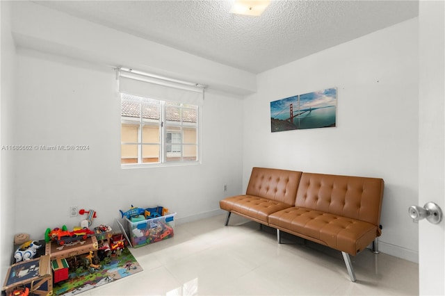 living area with a textured ceiling