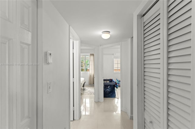 corridor featuring light tile patterned flooring