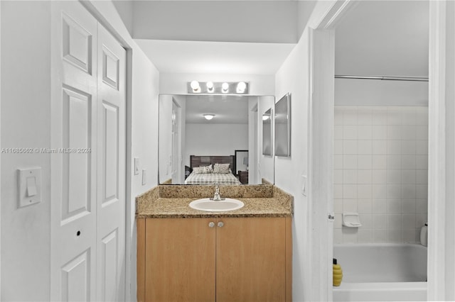 bathroom with vanity and a washtub