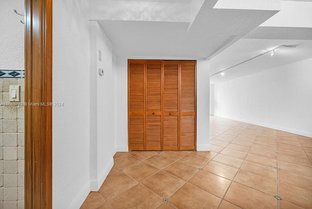 hallway featuring light tile patterned floors