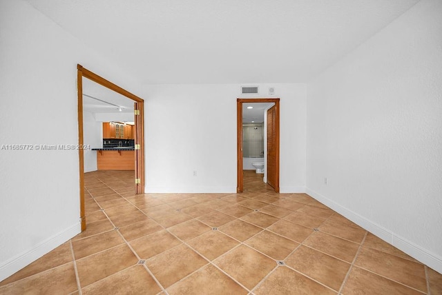 empty room with light tile patterned floors