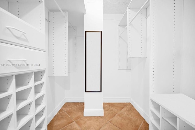 walk in closet featuring light tile patterned floors