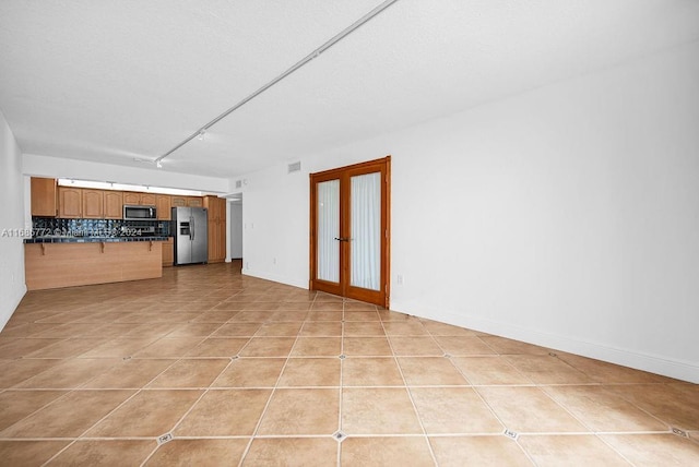 unfurnished living room with light tile patterned flooring