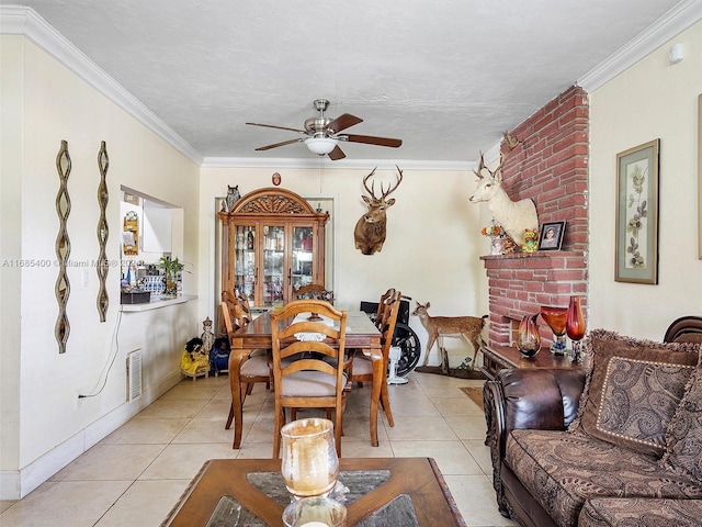 dining area featuring crown molding, a textured ceiling, light tile patterned floors, and ceiling fan