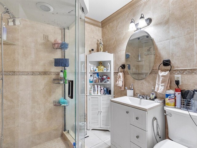 710 E 39th St, Hialeah, FL 33013 - full bathroom featuring a stall shower, vanity, tile walls, toilet, and tile patterned floors