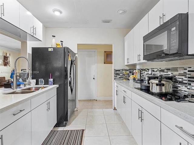 710 E 39th St, Hialeah, FL 33013 - kitchen featuring black appliances, a sink, light countertops, tasteful backsplash, and white cabinets