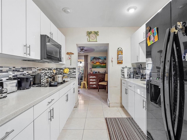 710 E 39th St, Hialeah, FL 33013 - kitchen featuring black appliances, backsplash, light countertops, and light tile patterned floors