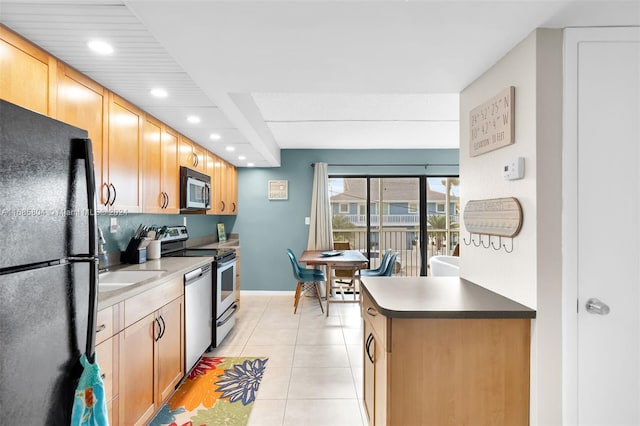 kitchen with stainless steel appliances and light tile patterned floors