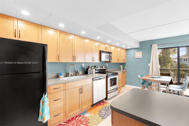 kitchen featuring backsplash, appliances with stainless steel finishes, light tile patterned floors, light brown cabinets, and sink