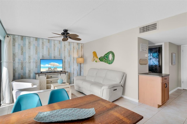 tiled living room featuring ceiling fan