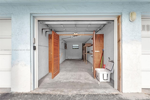 hall with concrete flooring