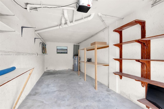 garage featuring a garage door opener and water heater