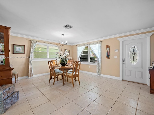 dining area featuring ornamental molding, a chandelier, and light tile patterned floors