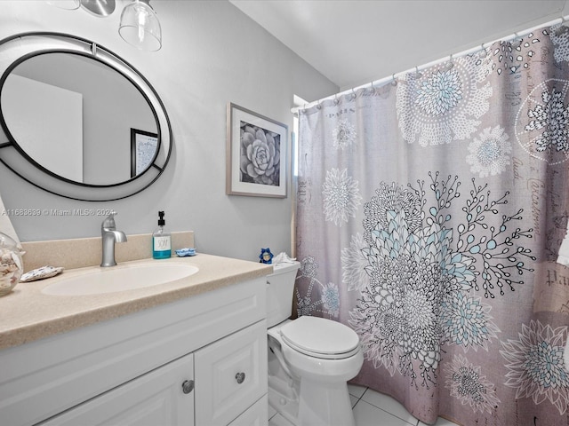 bathroom featuring toilet, walk in shower, vanity, and tile patterned flooring