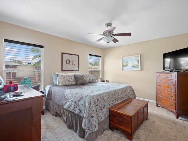 bedroom with light colored carpet and ceiling fan