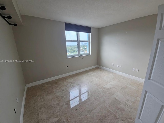 empty room with a textured ceiling