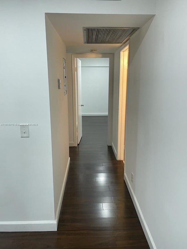 hallway featuring dark hardwood / wood-style flooring