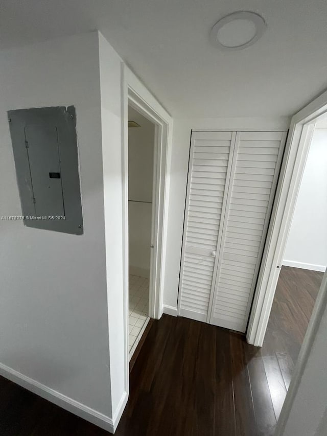 corridor featuring electric panel and dark hardwood / wood-style flooring