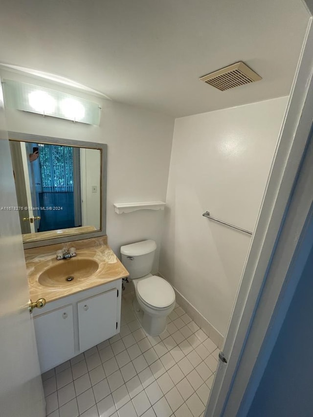 bathroom featuring vanity, toilet, and tile patterned floors