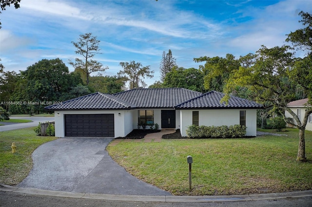 view of front of home with a front lawn and a garage