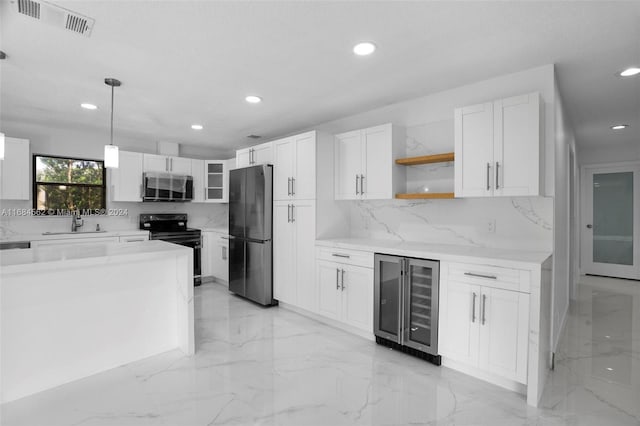 kitchen with wine cooler, white cabinets, appliances with stainless steel finishes, sink, and decorative light fixtures