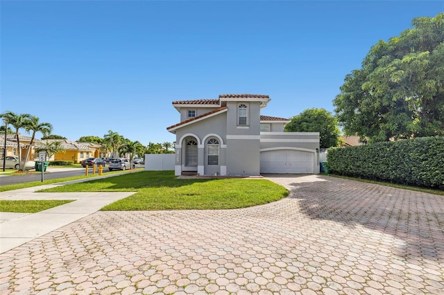 mediterranean / spanish-style home featuring a front yard and a garage