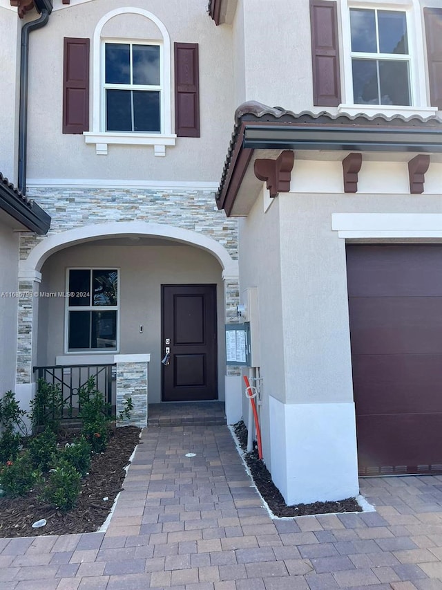 doorway to property featuring a garage