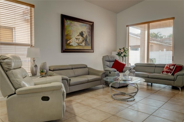 living room with a wealth of natural light, light tile patterned flooring, and vaulted ceiling