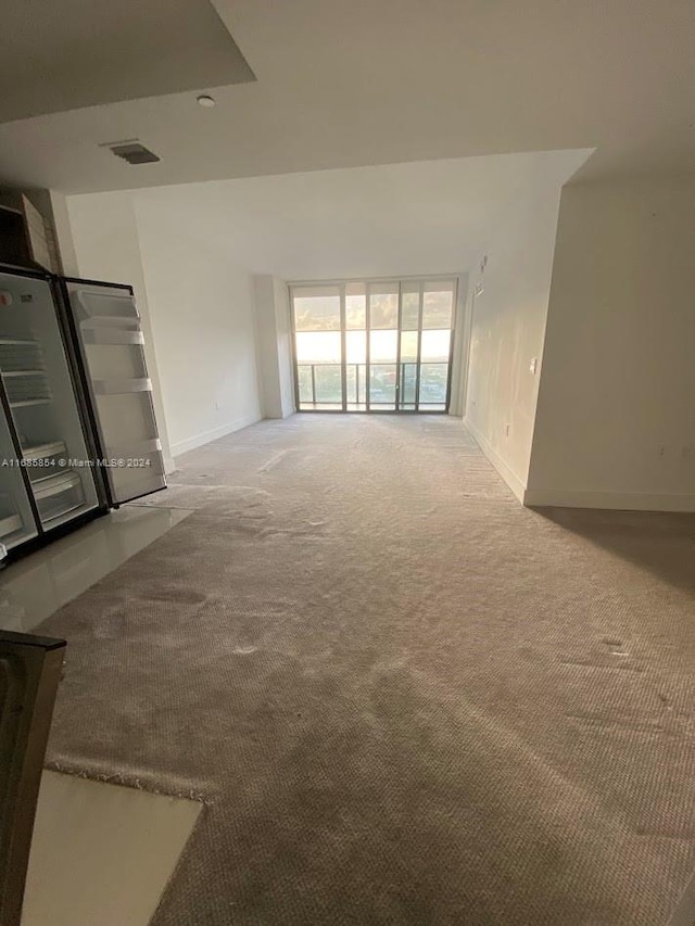 unfurnished living room with carpet floors