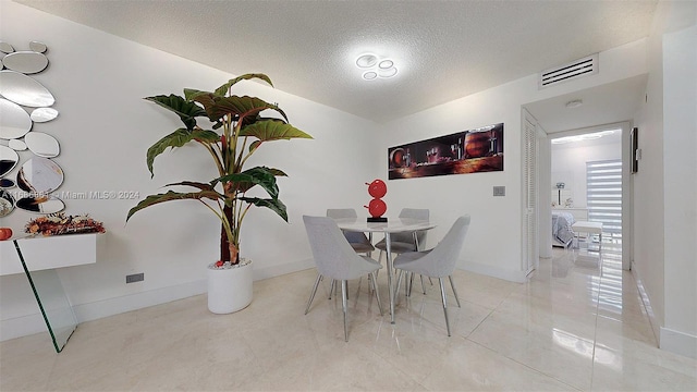 dining space with a textured ceiling