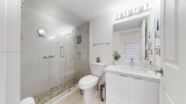 bathroom featuring toilet, an enclosed shower, vanity, and tile patterned floors