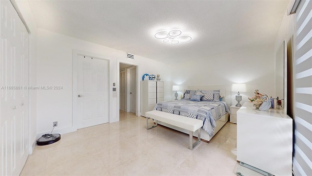 bedroom featuring a textured ceiling