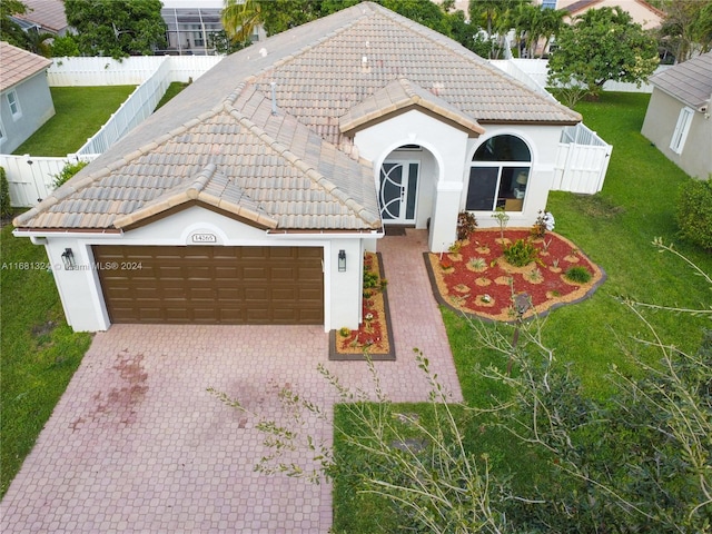 view of front of house with a garage and a front yard