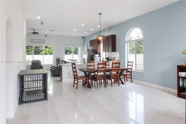 tiled dining space featuring ceiling fan and a healthy amount of sunlight