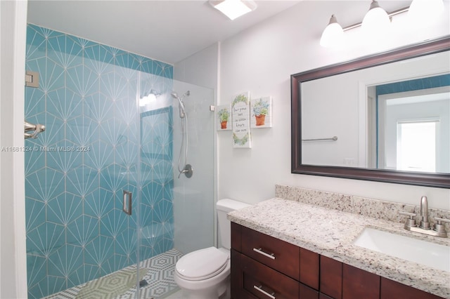 bathroom featuring an enclosed shower, vanity, and toilet