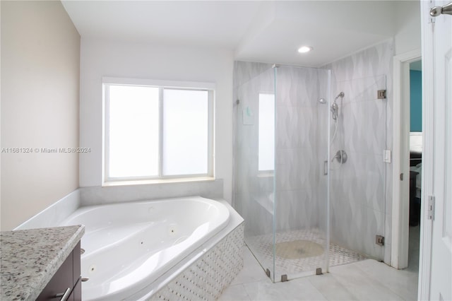 bathroom featuring vanity, tile patterned floors, and separate shower and tub