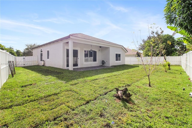 rear view of property with a patio and a yard