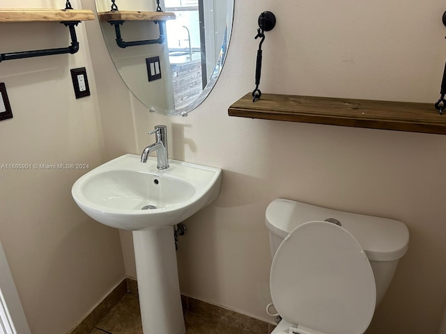 bathroom featuring toilet and tile patterned floors