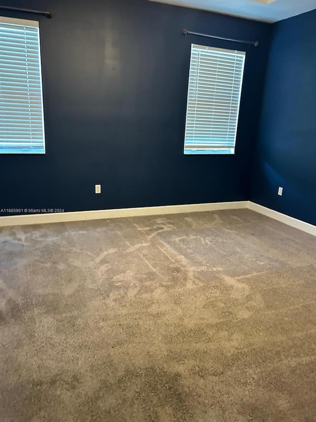 unfurnished room featuring carpet