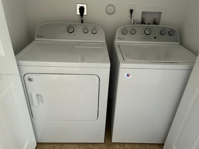 clothes washing area with washer and clothes dryer