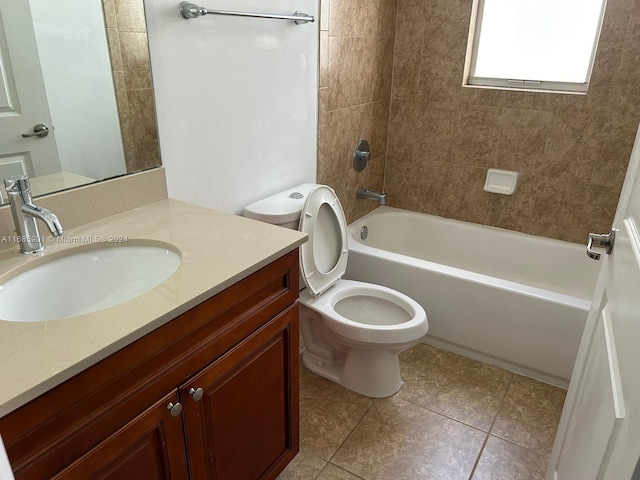 full bathroom featuring toilet, tiled shower / bath combo, vanity, and tile patterned floors