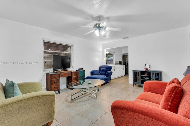 living room with ceiling fan and light tile patterned floors