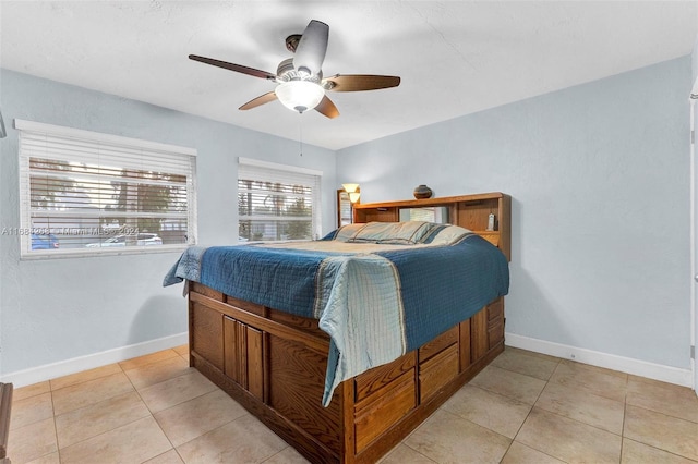 tiled bedroom featuring ceiling fan