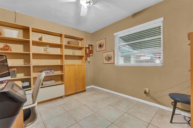 tiled office featuring ceiling fan