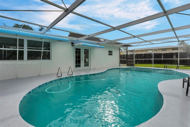 view of pool featuring a patio area and glass enclosure