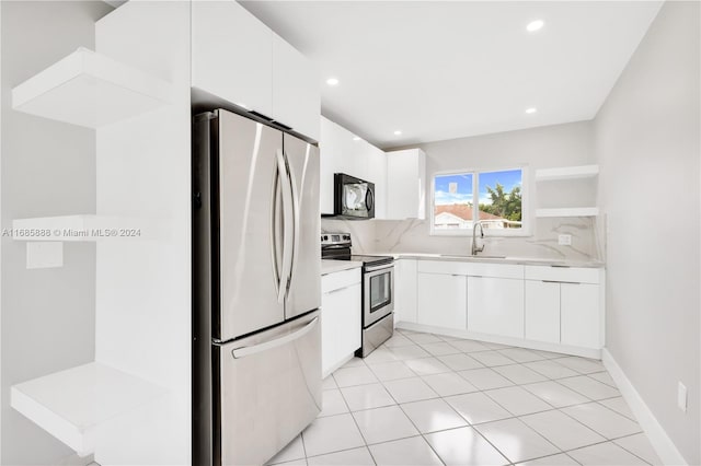 kitchen featuring sink, stainless steel appliances, white cabinets, decorative backsplash, and light tile patterned floors