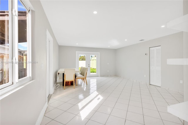 sitting room with french doors and light tile patterned floors