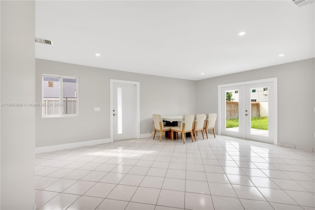 unfurnished dining area featuring french doors and light tile patterned floors