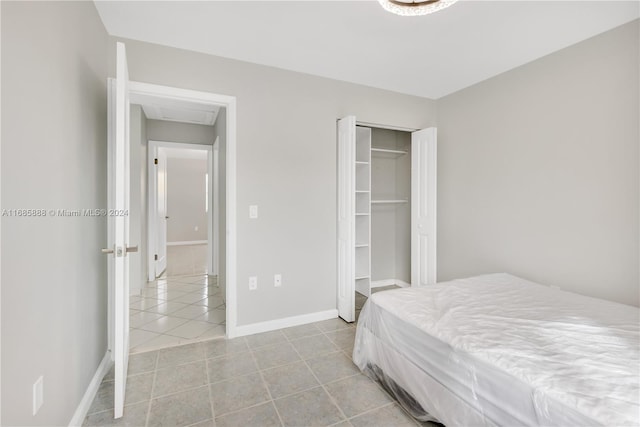 bedroom featuring a closet and light tile patterned floors