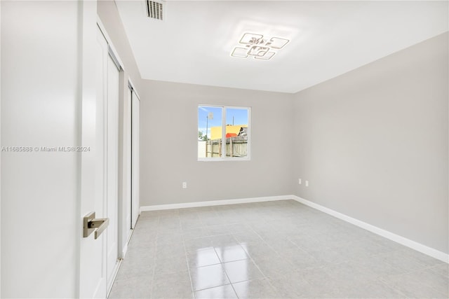 unfurnished bedroom with a closet and light tile patterned flooring